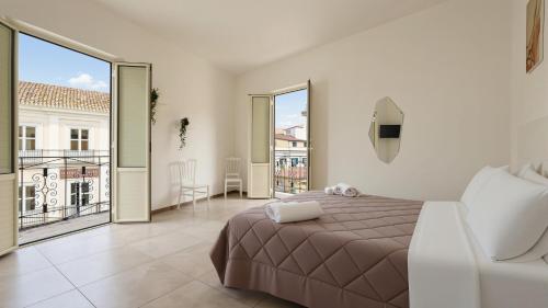 a bedroom with a large bed and a balcony at Il Marchesino B&B in Pizzo