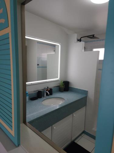 a bathroom with a sink and a mirror at Marina View in Les Trois-Îlets