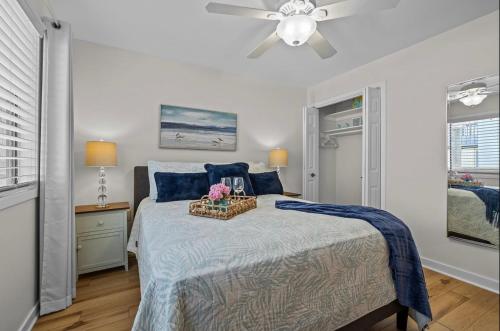 a bedroom with a bed and a ceiling fan at Mystic Sands in Emerald Isle