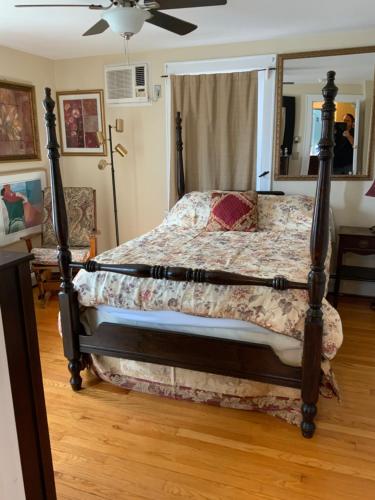 a bedroom with a bed with a wooden floor at Half a Mansion in Pomfret