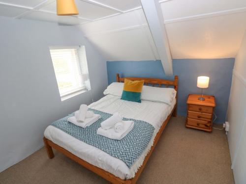 a bedroom with a bed with two towels on it at Beacon House in Haverfordwest