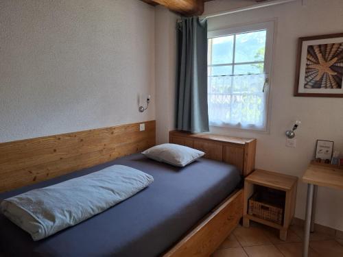 a bed in a room with a window at Hotel & Restaurant Rössli in Seedorf