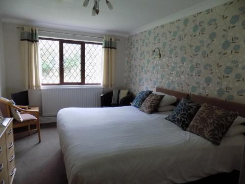 a bedroom with a large bed in a room at The Cottage Inn in Craster
