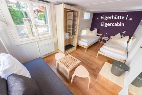 a small living room with a couch and a chair at Camping Jungfrau in Lauterbrunnen