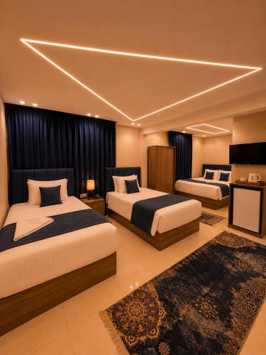 a hotel room with two beds in a room at Dima Plaza Pyramids View in Cairo