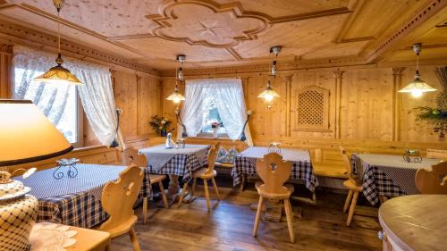 a restaurant with blue and white tables and chairs at Hotel Brunella in San Vigilio Di Marebbe