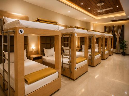 a group of bunk beds in a room at Hotel Unnati Stay Inn Vijayapura By HRG in Bijāpur