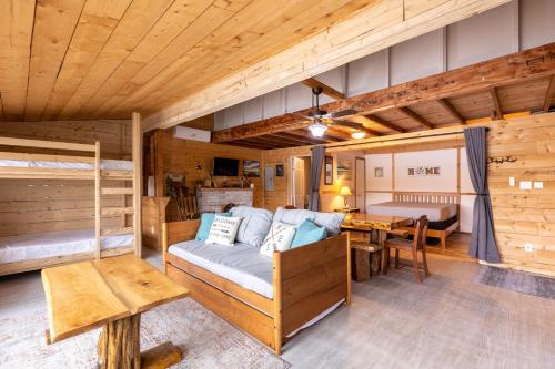 a bedroom with a bed and a table in a room at Lakefront Glamping Cottage- Fishing-Swimming-Boating in Watertown