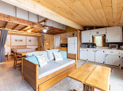 a living room with a couch and a kitchen at Lakefront Glamping Cottage- Fishing-Swimming-Boating in Watertown