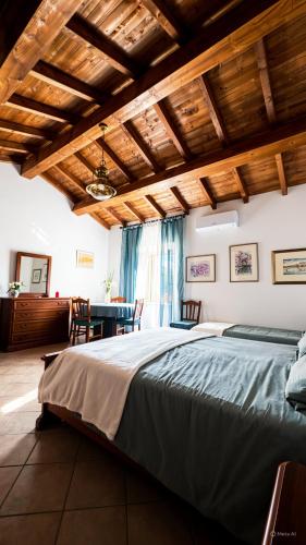 a bedroom with a large bed and a table at Il FONTANONE in Veiano