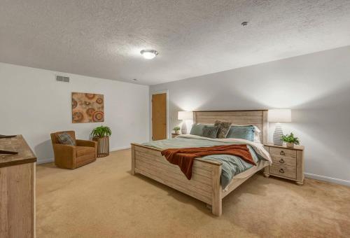 a bedroom with a large bed and a chair at Lakeview Condo Flats Parking Gym in Cleveland