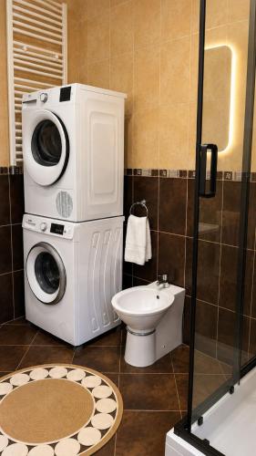 a bathroom with a washing machine and a toilet at Villa Besha in Herceg-Novi