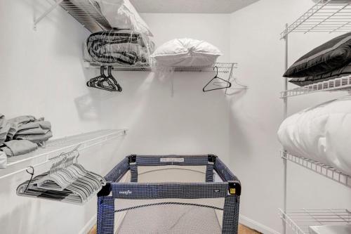 a walk in closet with a white wall at Lakeview Condo Flats Parking Gym in Cleveland