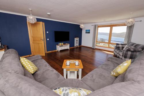 a living room with a couch and a table at Bellevue House, Shetland Islands in Whiteness