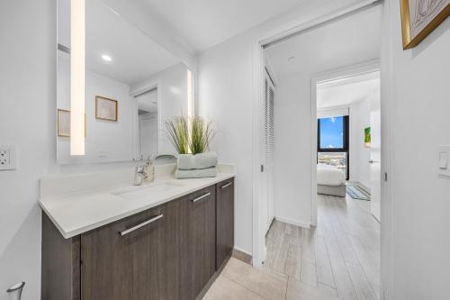a bathroom with a sink and a mirror at Miami Skyline Escape in Miami