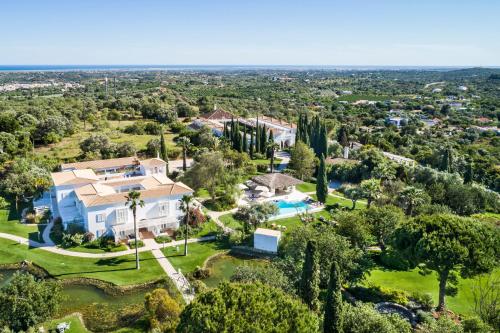 an aerial view of a house with a pool and trees at Octant Vila Monte in Moncarapacho