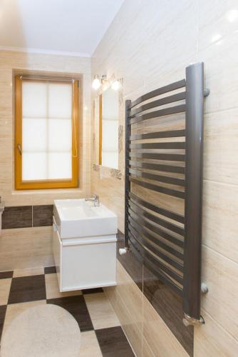 a bathroom with a sink and a mirror at Domek Góralski Suche in Suche
