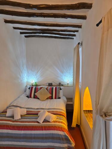 a bedroom with a bed in a room at Riad Patio des Amis Marrakech in Marrakesh