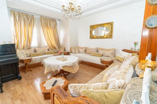 a living room with a couch and a table at Royal Moroccan Suite Central Tangier in Tangier