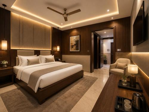 a bedroom with a large bed and a chair at Hotel City Palace in Pānīpat
