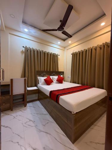 a bedroom with a bed with red pillows at Orchid 3BHK 3AC in New Town