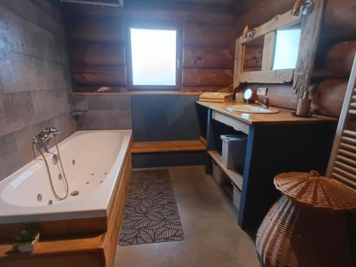 a bathroom with a tub and a sink at Lagarta La Fuste in Étival