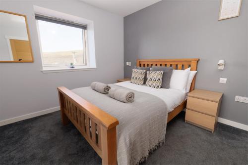 a bedroom with a large bed and a window at Bellevue Apartment, Shetland Islands in Whiteness