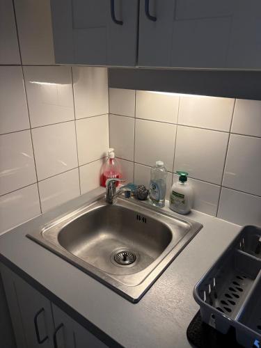 a kitchen sink with soap and detergents on it at DaxLodge T2 Chill in Dax