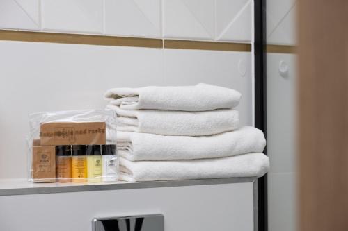 a stack of towels on a shelf in a bathroom at Rezydencja nad rzeką in Łeba