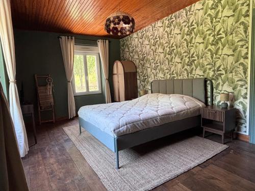 a bedroom with a bed in the corner of a room at La-Vialette Chambres d Hôtes in Mont-Roc