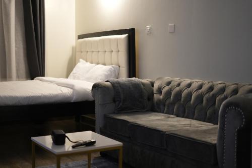 a living room with a couch and a bed at Elite Escape in Muchatha