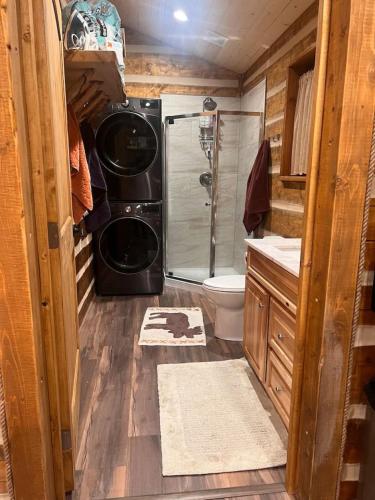 a small bathroom with a shower and a toilet at Homer Spit View Cabins - The Log Cabin in Homer