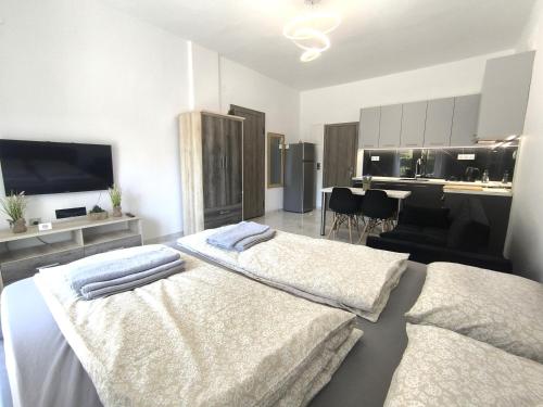 a bedroom with a bed with two towels on it at Rael Apartments - free Parking in Katerini