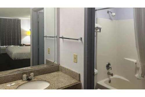 a bathroom with a sink and a mirror at Studio 6 Suites Louisville KY Airport/Expo Center in Louisville