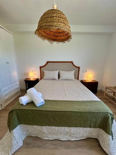 a bedroom with a bed with two pillows on it at Sol Dorado in Ferrero