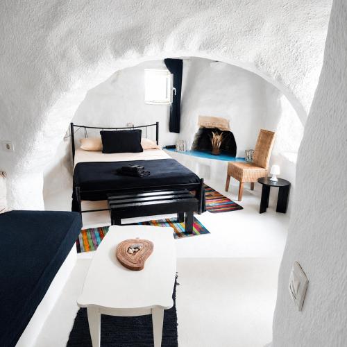 a bedroom with a bed and a piano at Artemis Cottage Authentic Mykonian Stone House near Super Paradise in Super Paradise Beach