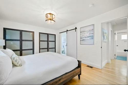 a white bedroom with a large bed and windows at Dana Point Lantern District Retreat Beach Close in Dana Point