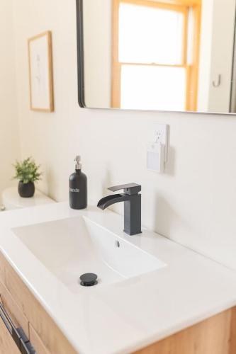 a bathroom with a white sink and a mirror at Lakefront Retreat Home- Swimming-Fishing-Boating in Bethlehem