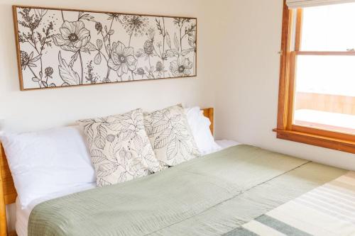 a bedroom with a bed with a picture on the wall at Lakefront Retreat Home- Swimming-Fishing-Boating in Bethlehem
