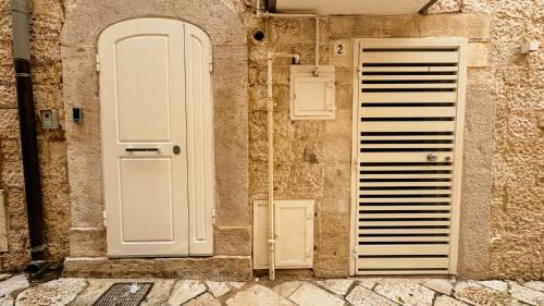 an entrance to a building with a white door at Duomo Charming Rooms in Barletta