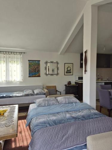 a bedroom with two beds and a table at Guest house Duletic in Budva