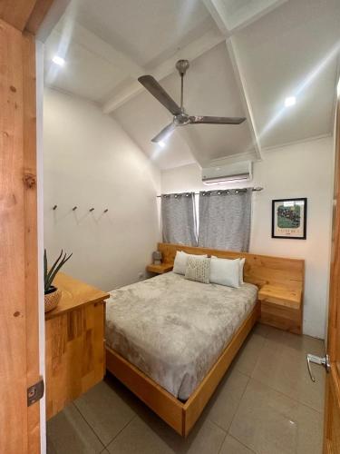 a bedroom with a bed and a ceiling fan at Villa Paradise in Jacó