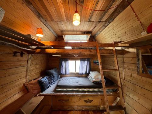a room with a bunk bed in a cabin at Rustic Cabin on Off-Grid Homestead in Brattfors
