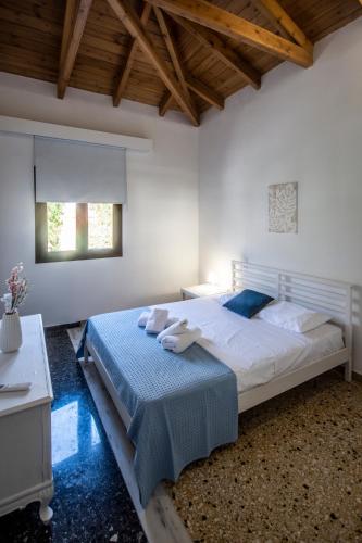 a bedroom with a large bed with towels on it at Αριάδνη in Archanes