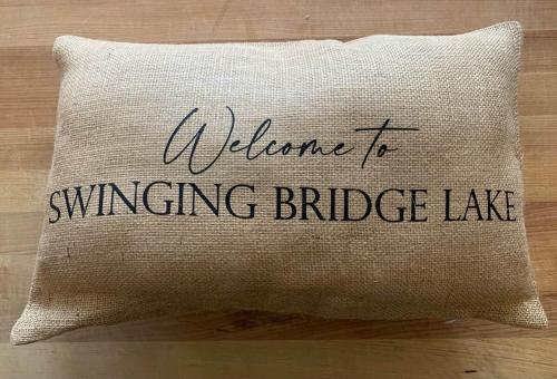 a pillow that says welcome to swinging bridge lake at Private Lakefront with Dock! in Bethel