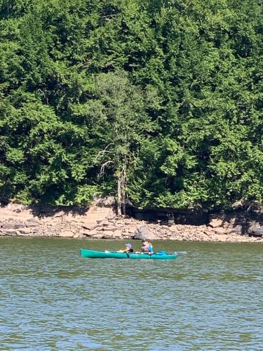 two people in a kayak on a body of water at Private Lakefront with Dock! in Bethel