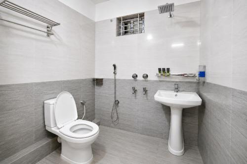 a bathroom with a toilet and a sink at Hotel Grand Darbar in Barisāl