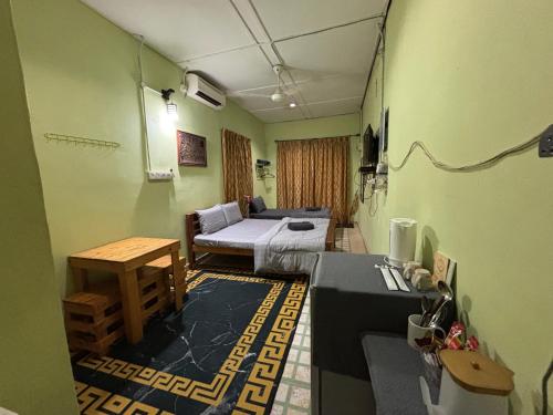 a room with a bed and a table in it at Studio Khalida Taman Perdana in Pekan