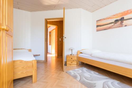 a bedroom with two beds and a mirror at Apartments Ilmtal-Jena in Jena