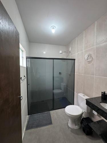 a bathroom with a shower and a toilet in it at Hotel Pousa Vale Imperial in Aparecida